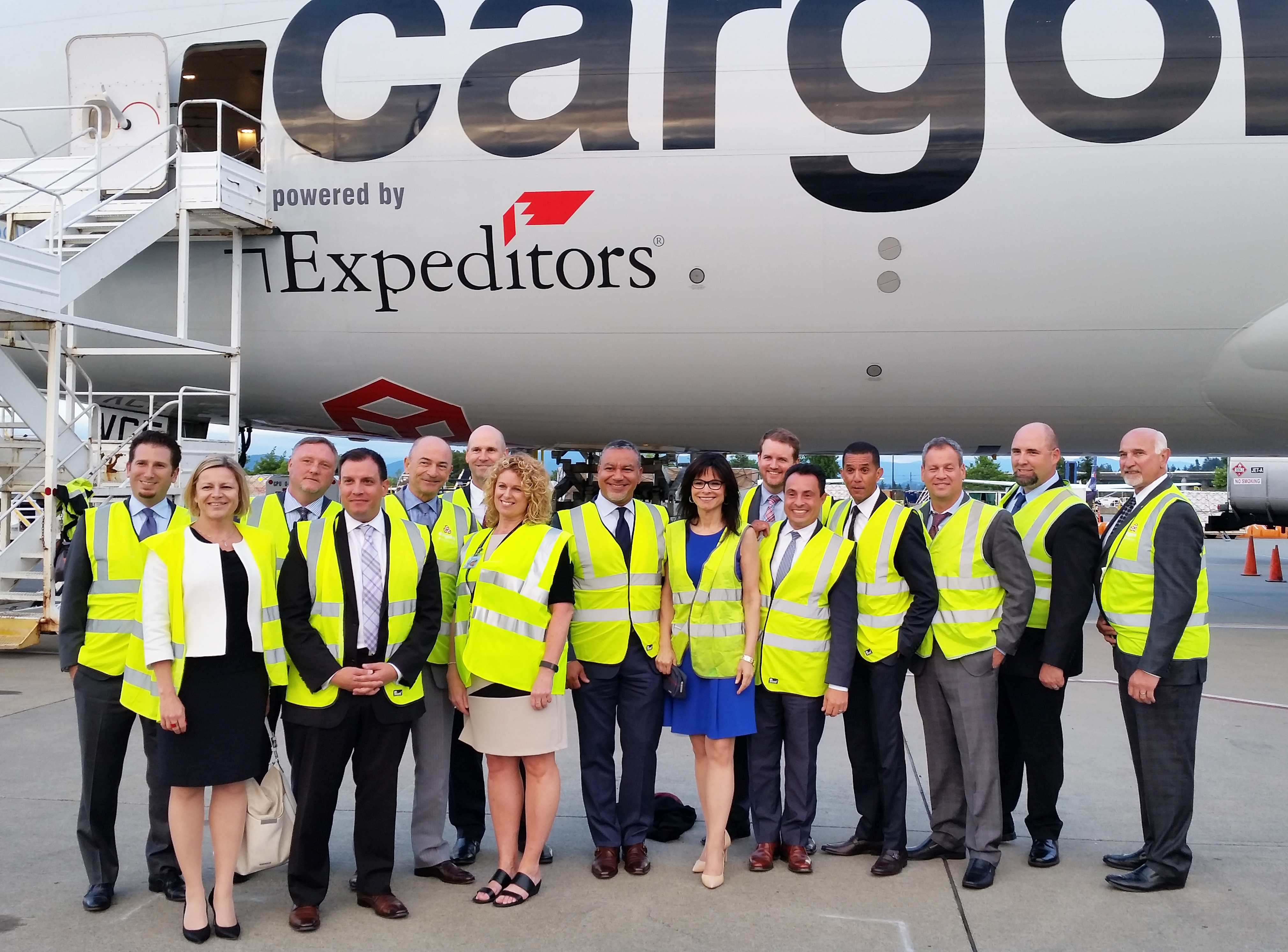 Executives from Expeditors and Cargolux welcome the freighter to Seattle.