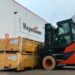 An Expeditors warehouse behind a forklift moving cargo