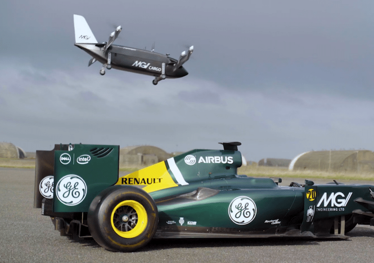 A MGI Mosquito drone hovers above an F1 race car.