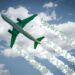 Aircraft soars through the sky leaving jet contrails with green leaves