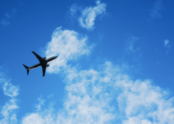 Silhouette of a plane against a blue sky