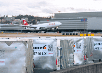 Cargo on a tarmac with a Swiss WorldCargo plane in the background