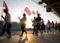 Striking Air Canada flight attendants hold flags