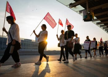 Striking Air Canada flight attendants hold flags