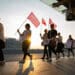 Striking Air Canada flight attendants hold flags
