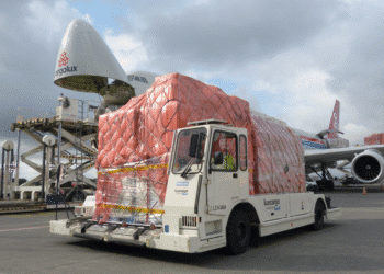 Air cargo on the tarmac in front of a Cargolux plane