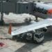 A refueling truck alongside a Jetstar plane at Singapore Changi Airport