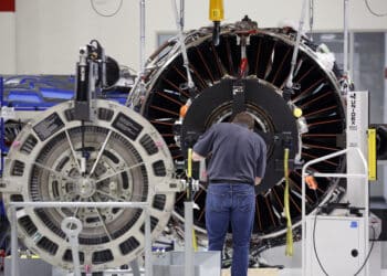 An employee assembles a jet engine at the General Electric Co. assembly plant in Lafayette, Indiana