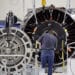 An employee assembles a jet engine at the General Electric Co. assembly plant in Lafayette, Indiana