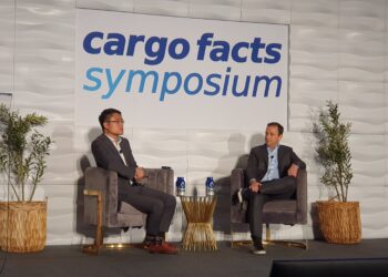 Jordan Frohlinger and Jeff Lee of Cargo Facts Consulting speak on the podium at Cargo Facts Symposium 2026.