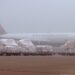 An Air Canada Cargo freighter in the mist with cargo pallets in front of it